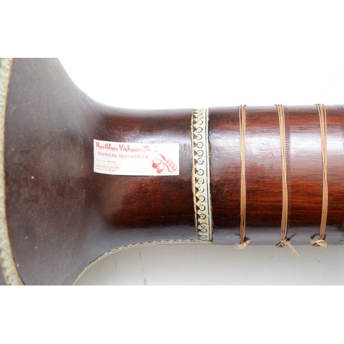 90 - An Indian Sitar, featuring five playing strings and eleven sympathetic strings and decorated with bo... 