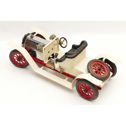 140 - A Mamod live steam roadster car with white body, black seat and red spoked wheels, with burner, unfi... 