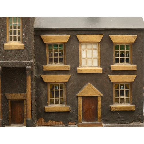 171 - A scratch built wooden model of three terraced houses in the Georgian style, set on an imitation bri... 