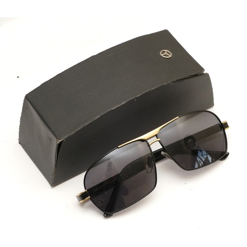 231 - A pair of Mercedes Benz branded sunglasses, serial no. MB722 65 12-142, complete with case.