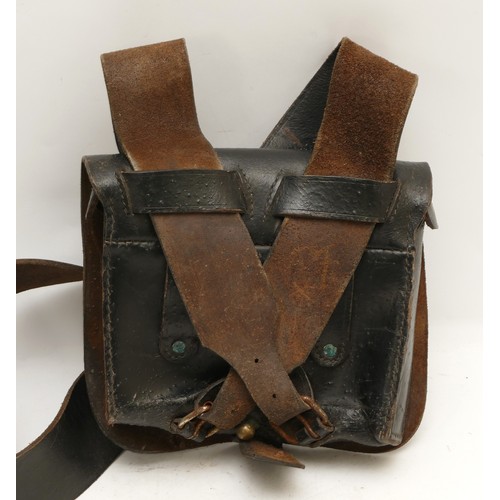 253 - An American black leather ammo shoulder Bag, having broad shoulder strap, the flap with brass button... 