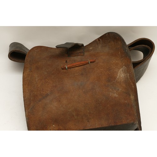 253 - An American black leather ammo shoulder Bag, having broad shoulder strap, the flap with brass button... 