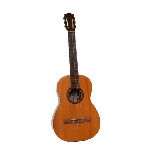 115 - A 20th century Spanish acoustic guitar, paper makers label attached, with carry case, 95cm long.