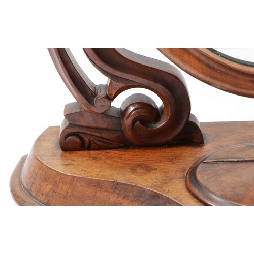 27 - A Victorian mahogany swing dressing table mirror, with lidded compartment, the cradles with scroll w... 