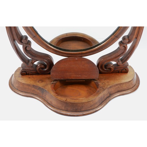 27 - A Victorian mahogany swing dressing table mirror, with lidded compartment, the cradles with scroll w... 