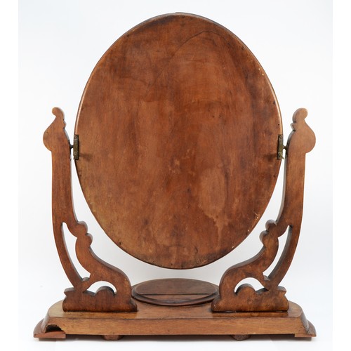 27 - A Victorian mahogany swing dressing table mirror, with lidded compartment, the cradles with scroll w... 