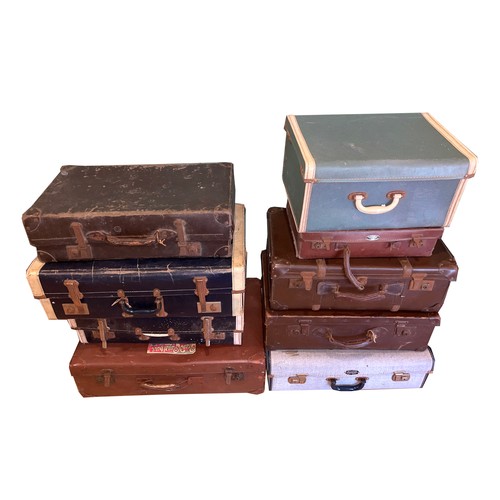 28 - Nine vintage and antique suitcases, to include, leather and fabric examples, one being decorated wit... 