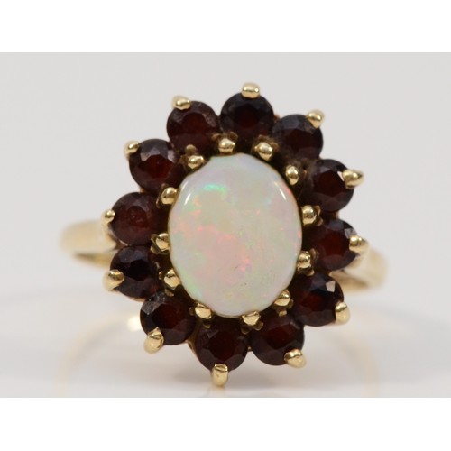 33 - A 9ct gold opal and garnet cluster ring, 10mm x 7mm opal, R, with original box and receipt, 4g