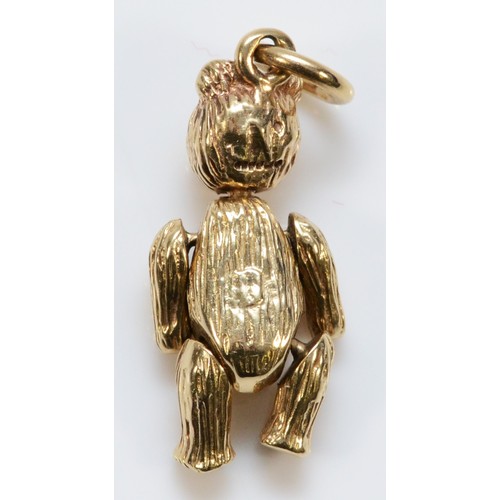 42 - A 9ct gold pendant in the form of a bear with articulated arms and legs and movable head, 23mm lengt... 