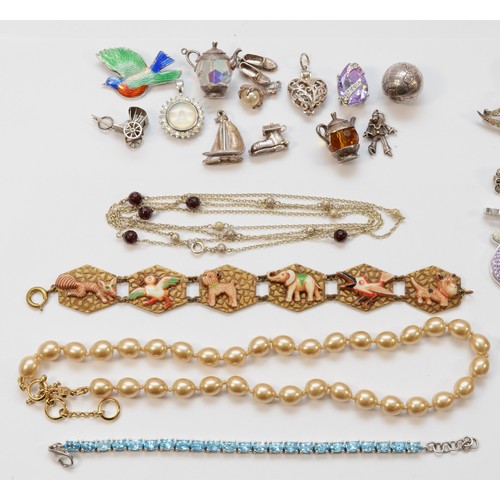 45 - A collection of 925 silver chains, 925 silver charms in the form of a ship, shoes and a boot, a Kirk... 