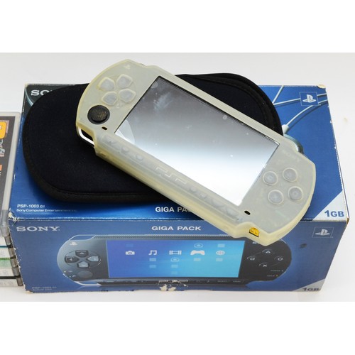 73 - A PSP console, model no. PSP-1003 G1, boxed, together with six games, to include, Prince of Persia R... 