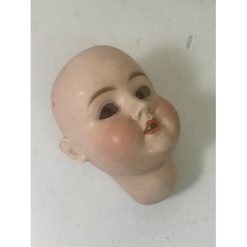 165 - A large antique German bisque dolls head, with sleeping eyes, an open mouth revealing teeth and pain... 