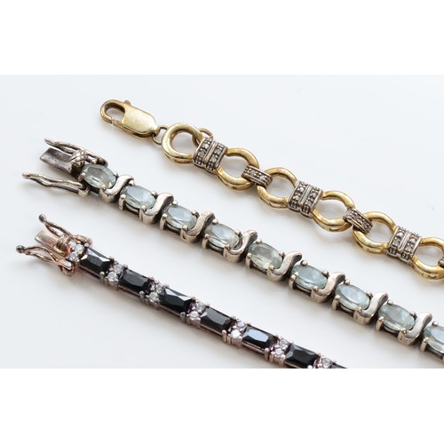 106 - A silver gilt and diamond set line bracelet, 19.5cm, and two silver and gemset bracelets18.5 and 19c... 