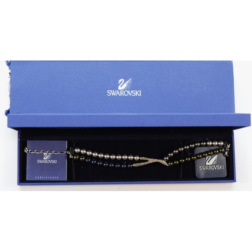 175 - Swarovski crystal and imitation pearl bracelet, with tag, certificate and box, a silver and garnet p... 