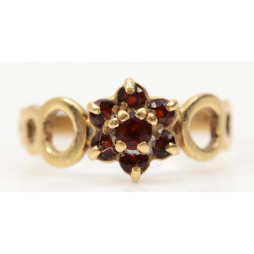 200 - A 9ct gold garnet flower cluster ring, Birmingham 1979, openwork shoulders, L, 1.6g