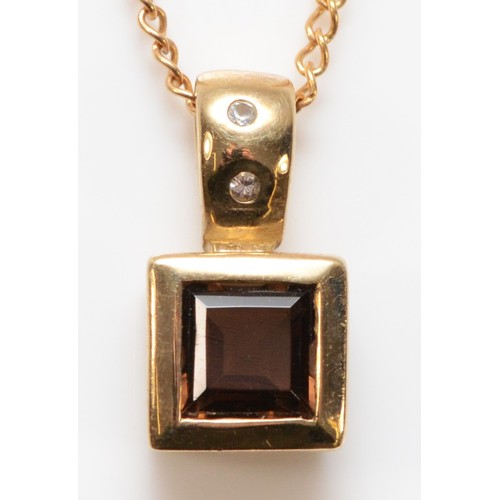 720 - A 9ct gold smokey quartz and white gemstone pendant with a chain, 14mm total pendant drop, 2.7g