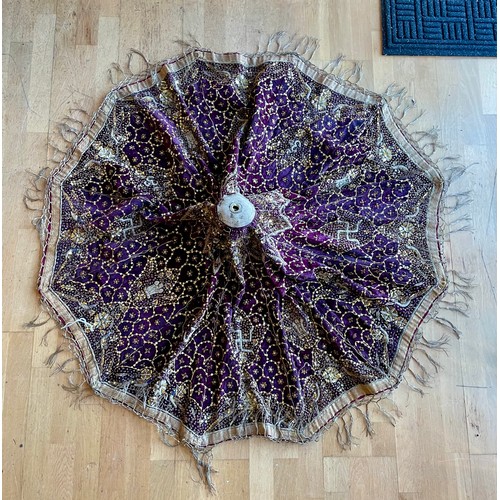 A late 19th century Indian, purple brocade, circular parasol cover, embroidered with auspicious symbols, sequins and stitching, diameter 144cm.