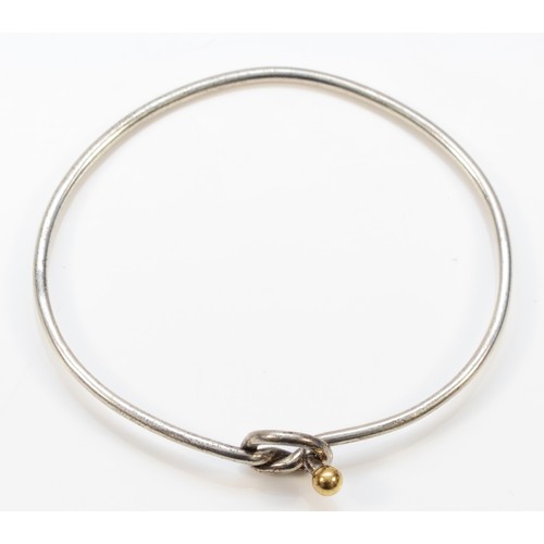 52 - Tiffany & Co., a silver bangle with 750/18ct gold ball detail, 7gm