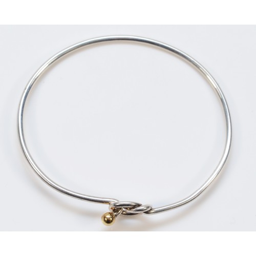 55 - Tiffany & Co., a silver bangle with 750/18ct gold ball detail, 7gm