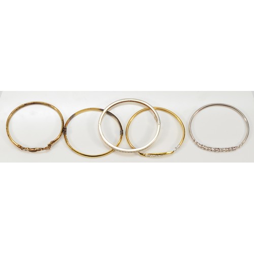 58 - Three silver and bonded gold hinged bangles and two silver hinged bangles (5), 56gm