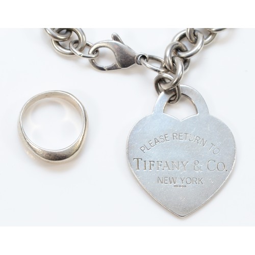 96 - Tiffany & Co., a silver curb link bracelet with heart disc, London 2004 and a Tiffany & Co., silver ... 