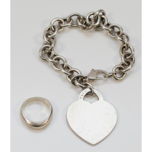 96 - Tiffany & Co., a silver curb link bracelet with heart disc, London 2004 and a Tiffany & Co., silver ... 