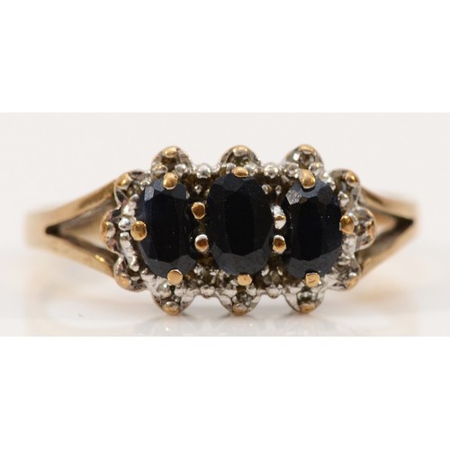 127 - A 9ct gold three stone sapphire and diamond cluster ring, P, 2.3g