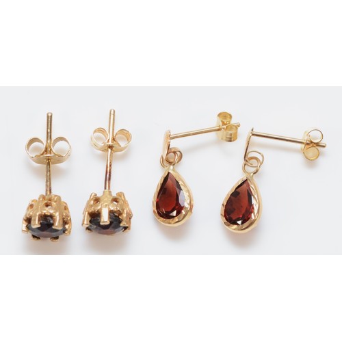 129 - Two pairs of 9ct gold garnet earrings with scroll backs, 2.1g