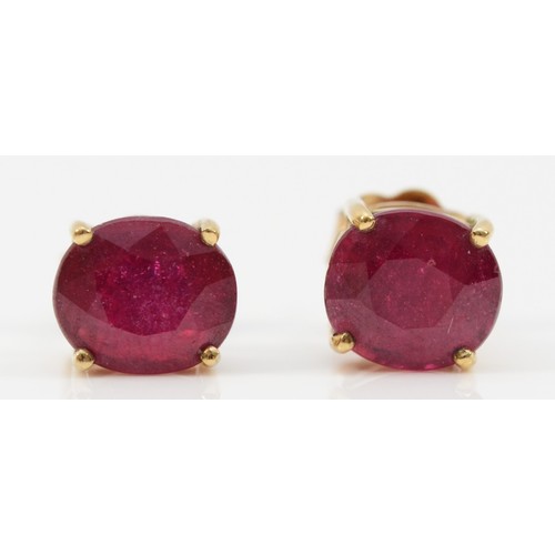 134 - A pair of 9ct gold glass filled ruby earrings with scroll backs, 2g