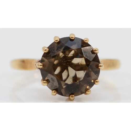 140 - A 9ct gold smokey quartz single stone ring, Birmingham 1975, 10mm diameter, N 1/2, 2.8g