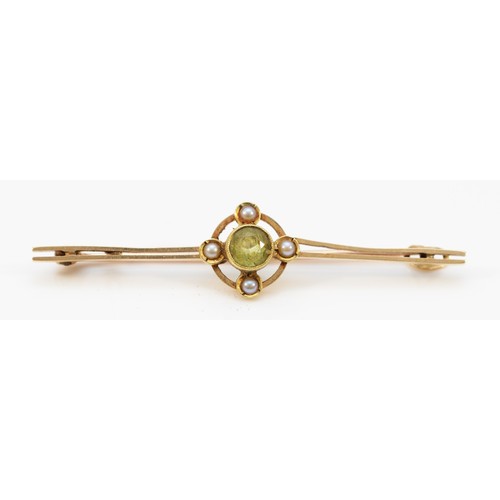 149 - A partially stamped 9ct gold Edwardian peridot and seed pearl bar brooch, 50mm across, 2.4g