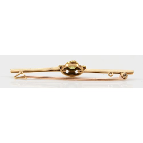 149 - A partially stamped 9ct gold Edwardian peridot and seed pearl bar brooch, 50mm across, 2.4g