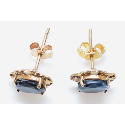 163 - A pair of 9ct gold sapphire earrings with scroll backs, 1.4g