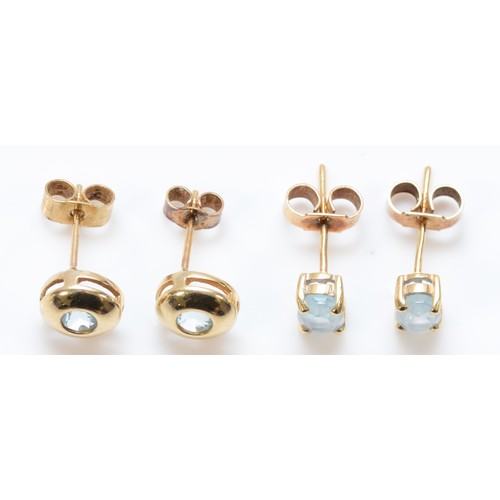 165 - Two pairs of 9ct gold blue gemstone earrings with scroll backs, 2g