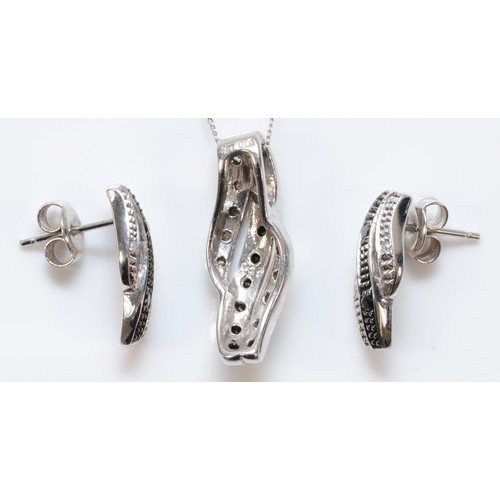 187 - A pair of 9ct white gold diamond and black gemstone earrings with scroll backs, together with a matc... 