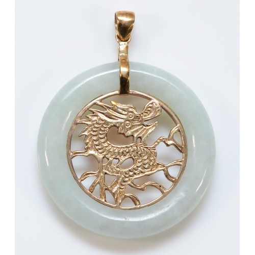 198 - A 9ct gold jade pendant with a central dragon pattern, 30mm diameter, 6.8g