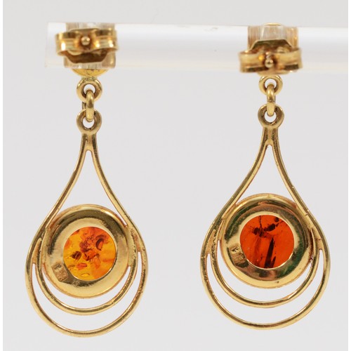 223 - A pair of 9ct gold amber drop earrings with scroll backs, 35mm total length, 3.6g