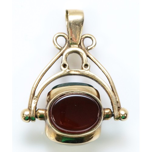 234 - A 9ct gold mother of pearl, blood stone and carnelian spinning fob, 25mm drop, 4.2g