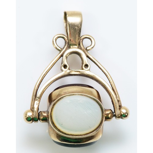 234 - A 9ct gold mother of pearl, blood stone and carnelian spinning fob, 25mm drop, 4.2g