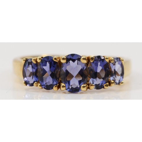 244 - A 9ct gold iolite five stone ring, graduating sizes of iolite, S, 2.9g