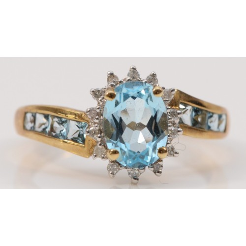 255 - A 9ct gold blue topaz and diamond dress ring, topaz set shoulders, N, 2.7g