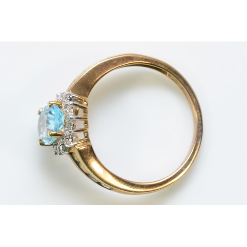 255 - A 9ct gold blue topaz and diamond dress ring, topaz set shoulders, N, 2.7g