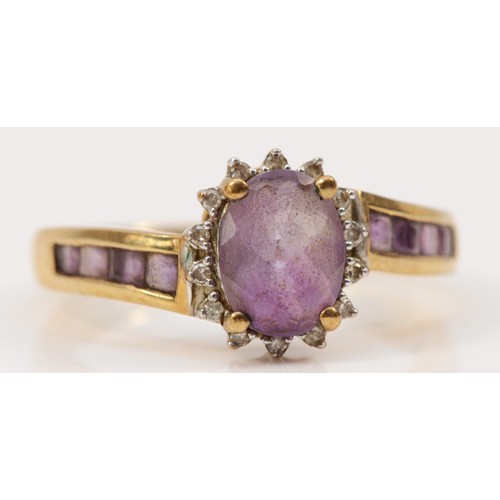 256 - A 9ct gold amethyst and diamond dress ring, amethyst set shoulders, O, 3g