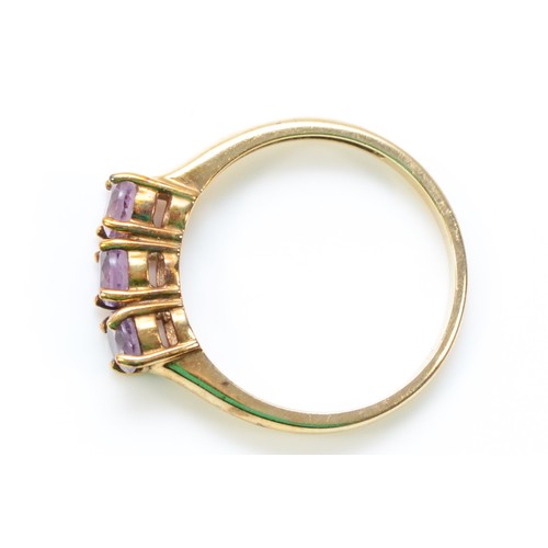 257 - A 9ct gold amethyst three stone ring, N, 2.1g