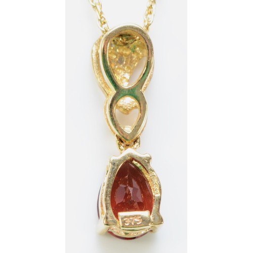 268 - A 9ct gold diamond and garnet pendant with a chain, 17mm drop, 1.9g