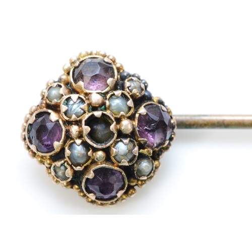 293 - An unmarked 9ct gold amethyst and seed pearl stick pin, 65mm length, 1.5g