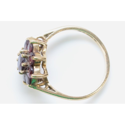 295 - A 9ct gold garnet floral cluster ring, L, 2.7g