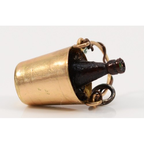 300 - A 9ct gold charm in the form of a champagne bucket with bottle, 25mm length, 1.6g