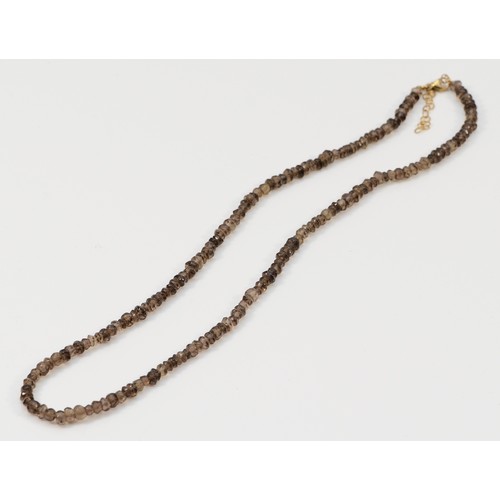 323 - A 9ct gold clasp smokey quartz beaded necklace, 12.3g