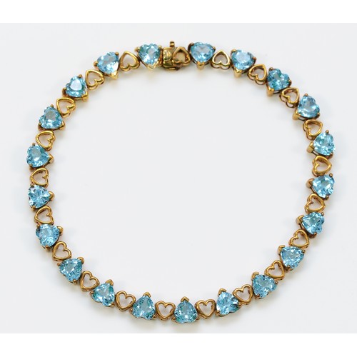 337 - A 9ct gold heart shaped blue gemstone bracelet, 18cm, 8.9g